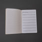 Musician's staff paper notebook, pocket edition, interior with ruled paper on left, staff composition paper on right