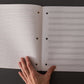 Musician's staff paper notebook, slim ruled edition, interiors showing ruled paper on left and staff paper on right